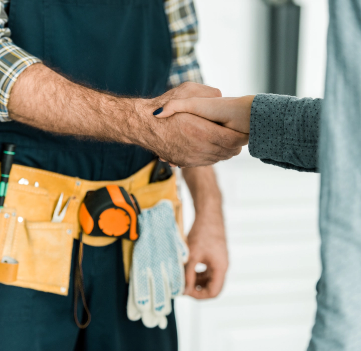 handyman shaking hands with client