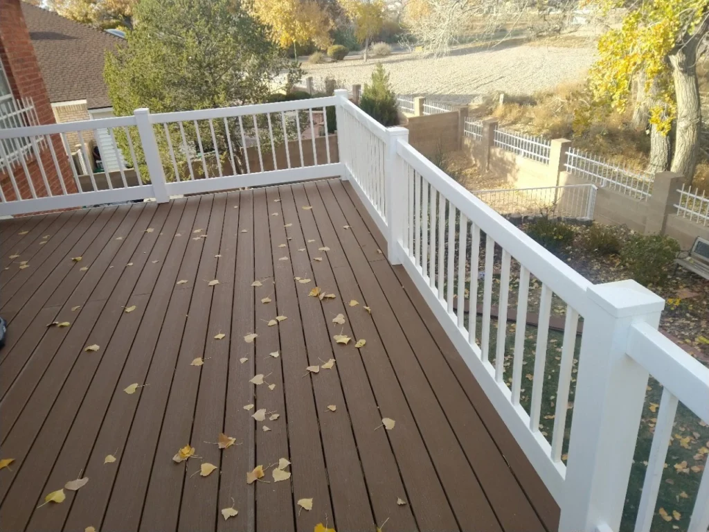 omposite deck installation by TC Canyon Ventures in Albuquerque, NM featuring gray multi-tone decking boards and stucco walls