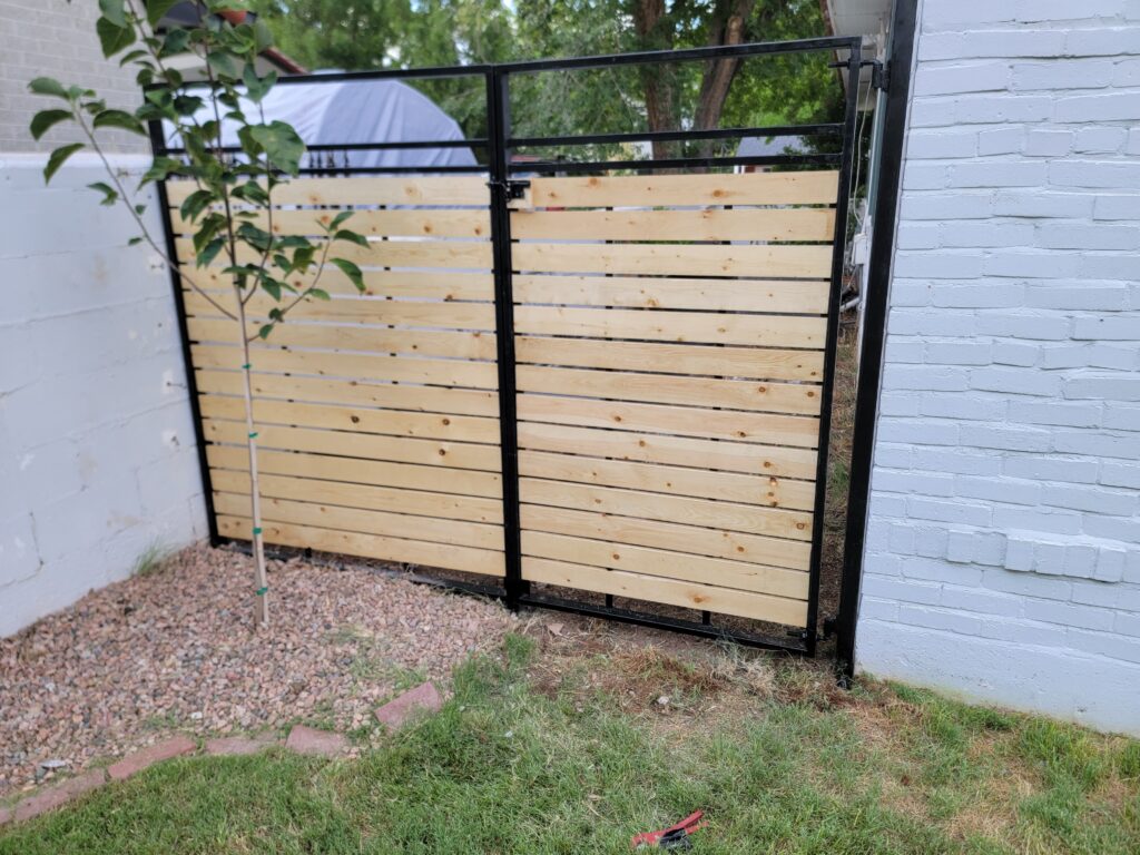 Custom horizontal wood and metal fence gate installed by TC Canyon Ventures in Albuquerque, NM
