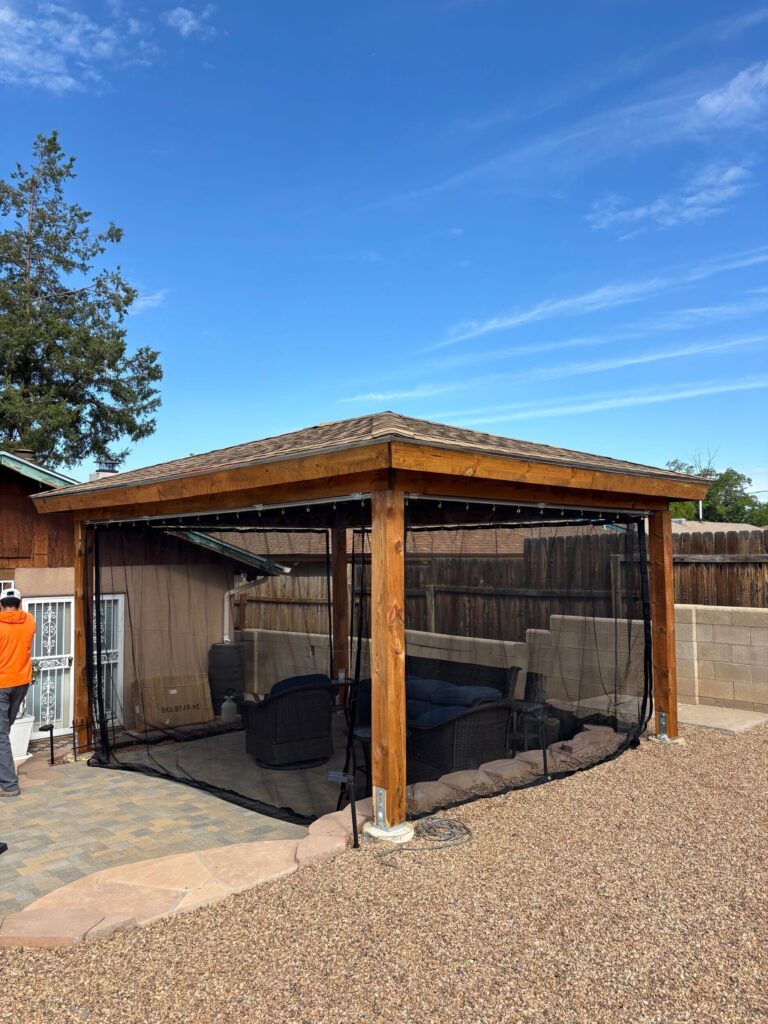 Custom wood gazebo with mosquito netting and shingle roof built by TC Canyon Ventures in Albuquerque, NM
