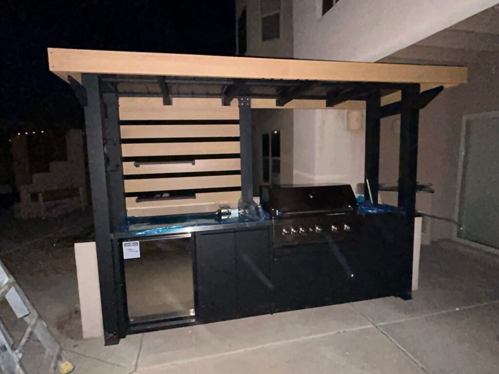 Custom outdoor kitchen with built-in grill and pergola cover installed by TC Canyon Ventures in Albuquerque, NM